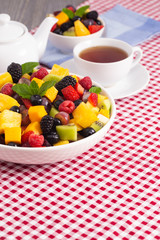 Table Set for Breakfast with Fresh Fruit Salad on a Red Plaid Table Cloth