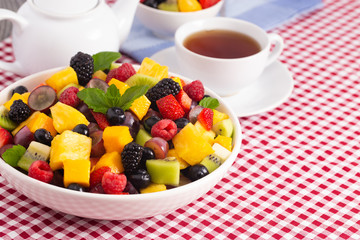 Table Set for Breakfast with Fresh Fruit Salad on a Red Plaid Table Cloth