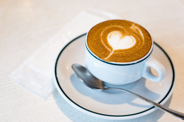 Takadanobaba, Japan, 03/23/2019 , Macchiato coffee, with a heart decoration on top with the creamy silky milk, on an italian restaurant.