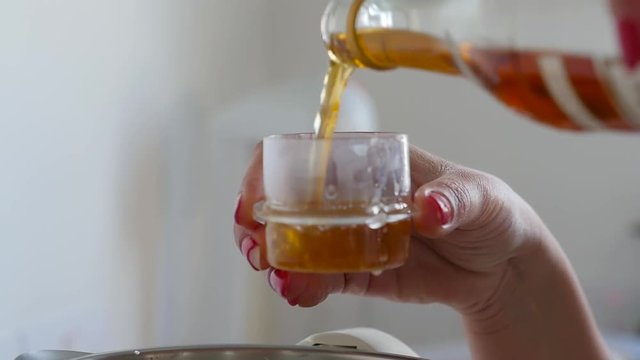 Close-up of measuring out vinegar for a recipe