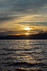 A scenic sunset over the dark-silver waters