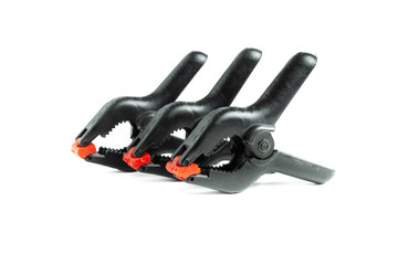 black plastic clamp. repair equipment tool. device for hold objects.