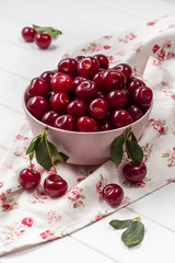 Cherry fresh in a pink plate on a light background