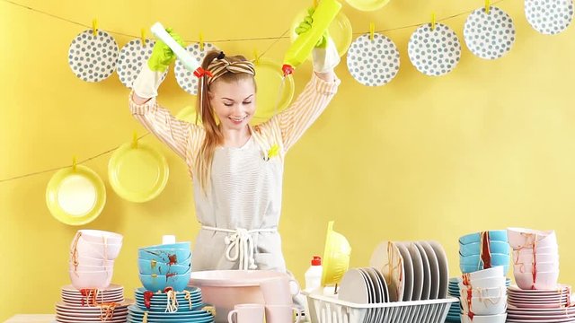 Creative attractive housewife doing experiments with dishwashing soap. Girl is preparing to wash the dishes. Job, professiona and occupation