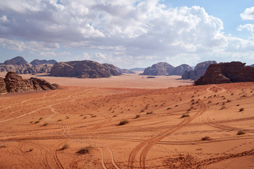 Fototapeta na wymiar Panoramic view to the landscape of the Wadi Rum desert with red sand dunes and rocks in Jordan. 