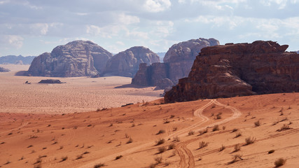 Fototapeta na wymiar Panoramic view to the landscape of the Wadi Rum desert with red sand dunes and rocks in Jordan. 