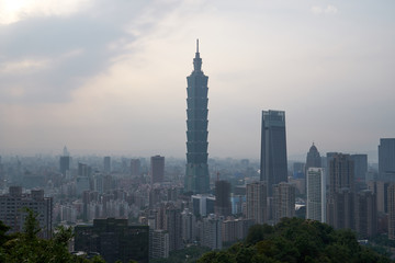 Fototapeta premium Aerial panoramic view to the cityscape of Taipei in Taiwan at sunset. Buildings and skyscrapers of the modern asian city architecture. 
