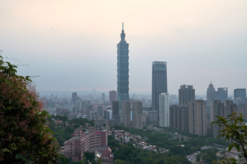 Fototapeta premium Aerial panoramic view to the cityscape of Taipei in Taiwan at sunset. Buildings and skyscrapers of the modern asian city architecture. 