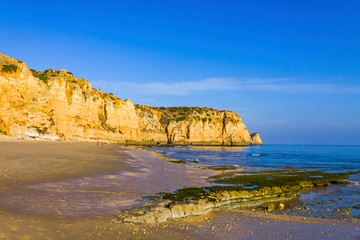 Praia do Porto de Mos, long beach in Lagos, Algarve region, Portugal. Beautiful golden beach, surrounded by impressive rock formations. Favourite spot for surfers and locals