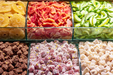 Dried fruits and turkish delight on the counter. In different colors and nuts, such as walnuts, nuts.