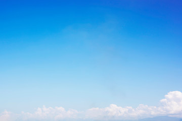 Blue sky background and white clouds soft focus, and copy space