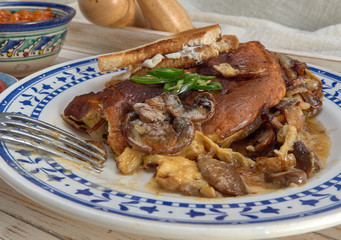 Omelet with fried onions and mushrooms.Baked beans and fresh tomatoes.On a wooden tray.