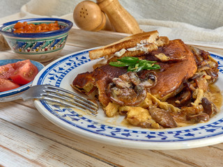 Omelet with fried onions and mushrooms.Baked beans and fresh tomatoes.On a wooden tray.