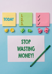 Conceptual hand writing showing Stop Wasting Money. Concept meaning advicing demonstrating or group to start saving and use it wisely Stationary placed sideways on top of the softhued backdrop