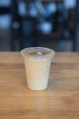 Iced milk coffee in plastic cup with cover.no straw.Indoor cafe
