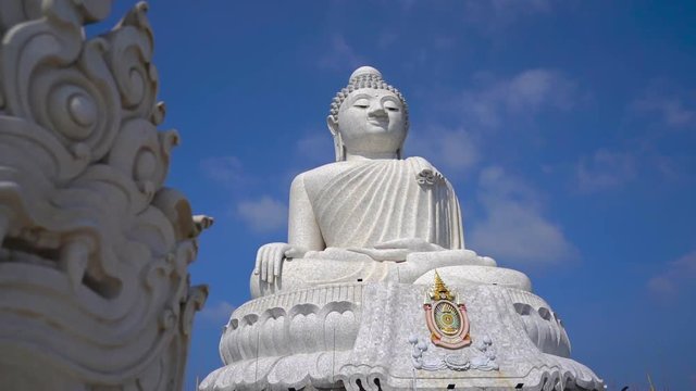 Slowmotion steadicam shot of a Big Buddha statue on Phuket island. Travel to Thailand concept