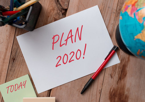 Word writing text Plan 2020. Business photo showcasing detailed proposal doing achieving something next year Writing equipments and sheets with artificial globe on the wooden desk