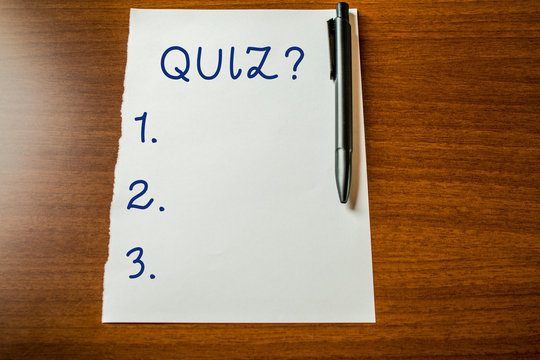 Handwriting text Quiz Question. Conceptual photo test of knowledge as competition between individuals or teams Upper view blank stationary paper lying wooden table pen. Writing essay
