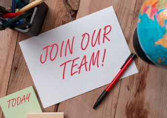 Word writing text Join Our Team. Business photo showcasing invite someone to work together for particular purpose target Writing equipments and sheets with artificial globe on the wooden desk