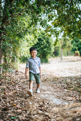 Happy boy playing alone in the park