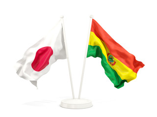 Two waving flags of Japan and bolivia isolated on white