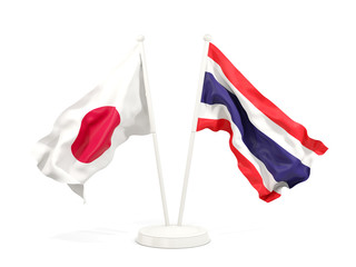 Two waving flags of Japan and thailand isolated on white