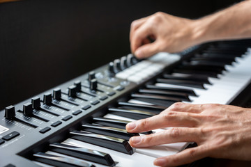Fototapeta na wymiar MIDI keyboard synthesizer piano keys closeup for electronic music production / recording