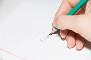 Text in pencil on paper I love you. Declaration of love on paper. Text on paper. I love you.