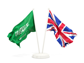 Two waving flags of Saudi Arabia and UK isolated on white