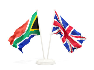 Two waving flags of South Africa and UK isolated on white