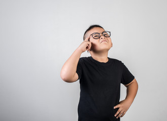 Funny Genius boy Thinking in studio shot