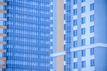 Fototapeta premium Windows of a high multi-storey residential building. High building. Residential high-rise building.