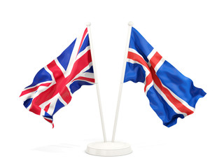 Two waving flags of UK and iceland isolated on white