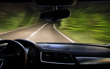 view of the night road through the windshield