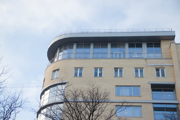 Windows of a high multi-storey residential building. High building. Residential high-rise building.