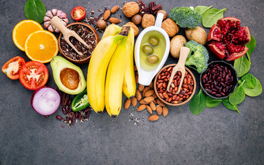 Ingredients for the healthy foods selection  .The concept of healthy food set up on dark concrete background copy space.