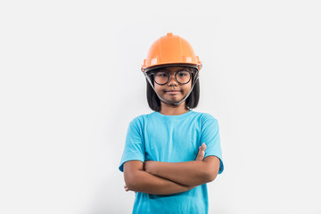 Little girl wearing orange helmet in studio shot