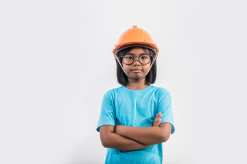Little girl wearing orange helmet in studio shot