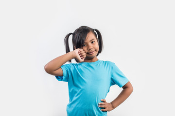 Portrait of Funny little girl acting in studio shot