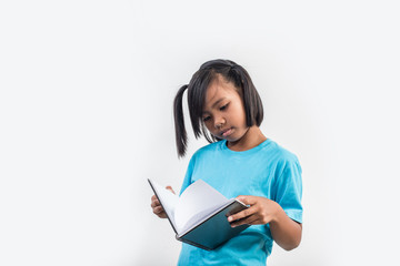little girl reading book in studio shot