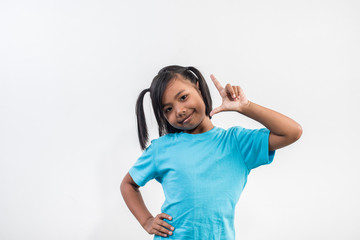 Portrait of Funny little girl acting in studio shot