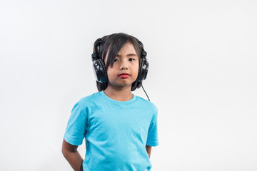 Little girl listening to music on wireless headphones