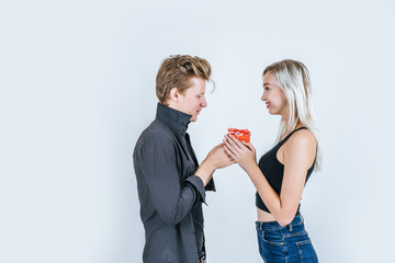 Portrait of happy young couple love together surprise with gift box in studio