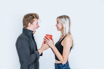 Portrait of happy young couple love together surprise with gift box in studio