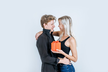 Portrait of happy young couple love together surprise with gift box in studio