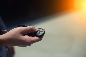 Hand pushing a car key button with copyspace