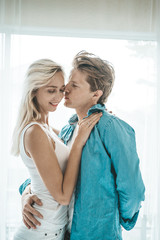 Fototapeta premium Happy Couple Playing together in the bedroom