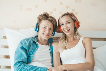 Happy couple listening song in the morning at bedroom