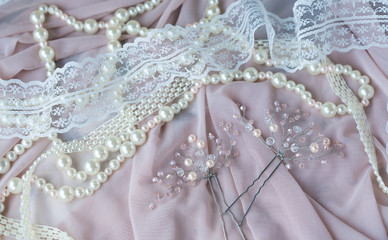 Wedding background with pearls and hair accessories on pink background