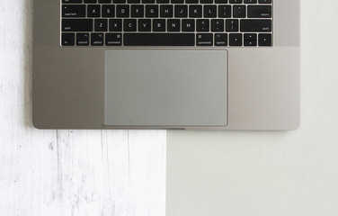 laptop keyboard on split gray wood background